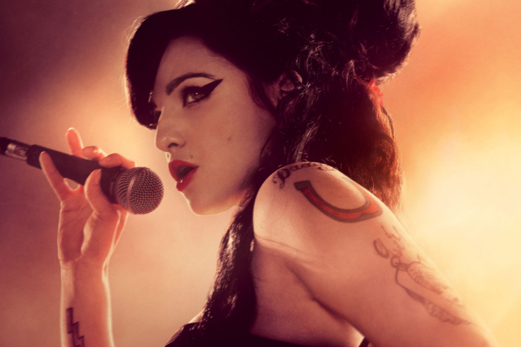 marisa abela as amy winehouse holding a microphone in the biopic back to black