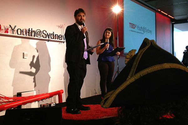 A slightly pirate hat—obstructed view of TEDx Youth@Sydney MCs James Colley and Susie Youssef