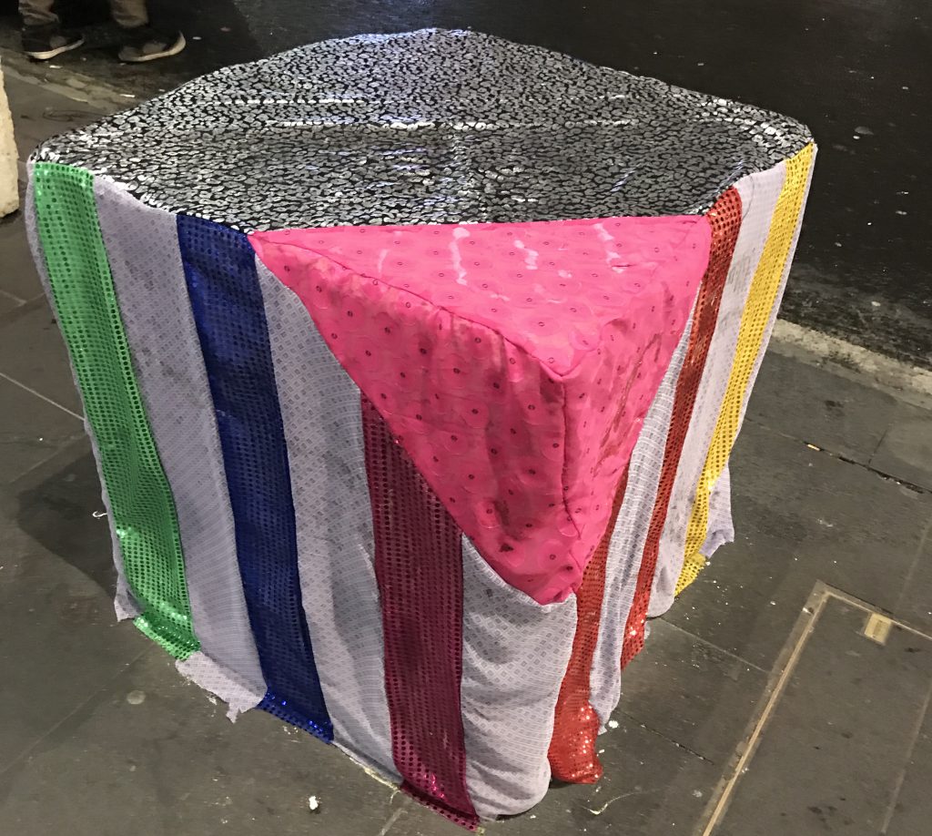 A fabric cover on one of Melbourne's anti-terror bollards, featuring iconic gay symbols such as the rainbow flag and pink triangle