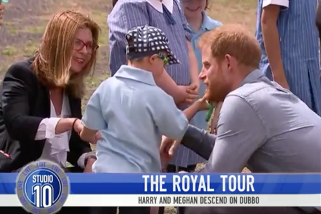 A small child grabs Prince Harry by the beard because why not?