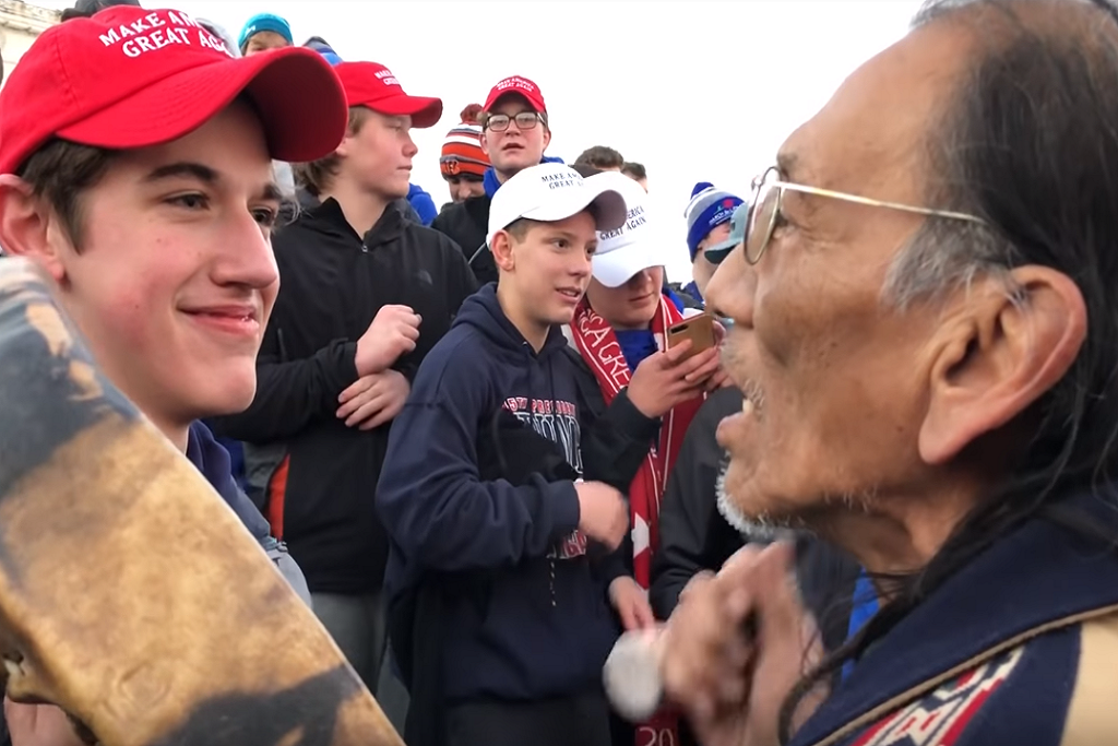 A Trump-supporting protester intimidates a member of the Indigenous Peoples March