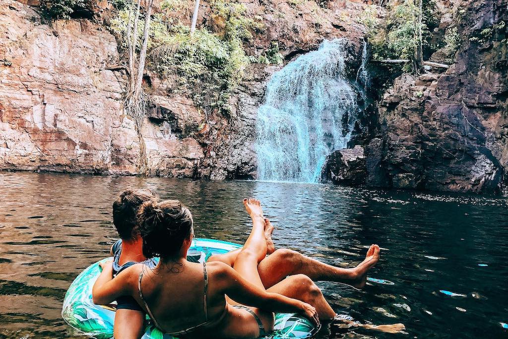 A couple swimming at Florence Falls waterhole in Litchfield National Park in Darwin
