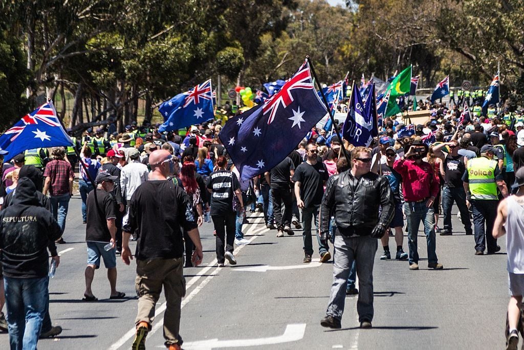 MELBOURNE, AUSTRALIA - NOVEMBER 22 : Supporters of the Reclaim Australia group march down the street waving flags and shouting anti-islamic slogans during a protest organized by the far right wing group as an anti-racist group stage rival demonstration in Melbourne, Australia on November 22, 2015. (Photo by Asanka Brendon Ratnayake/Anadolu Agency/Getty Images)