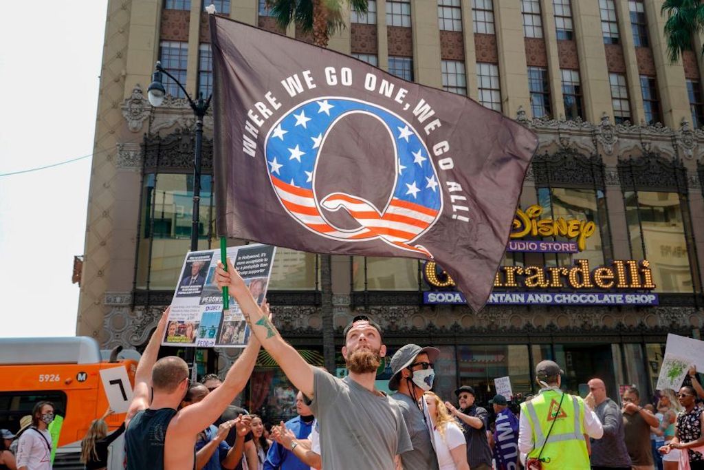 Conspiracy theorist QAnon demonstrators protest child trafficking on Hollywood Boulevard in Los Angeles, California, August 22, 2020. - A 2019 bulletin from the FBI warned that conspiracy theory-driven extremists are a domestic terrorism threat. (Photo by Kyle Grillot / AFP) (Photo by KYLE GRILLOT/AFP via Getty Images)