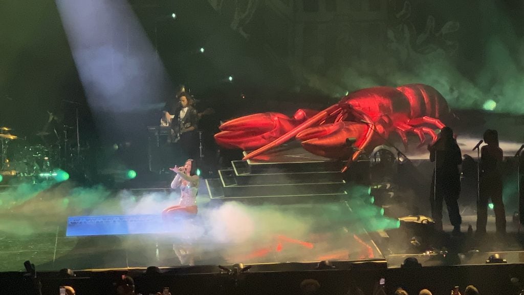 Dua Lipa sings onstage with a giant lobster 