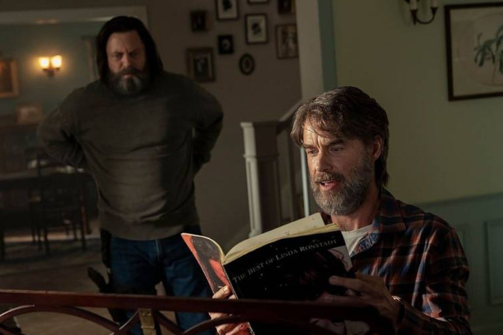 Actor Murray Bartlett sits at a piano while Nick Offerman looks on with his arms on his hips