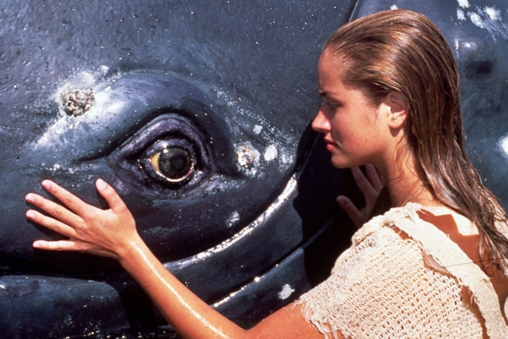 '90s Australian kids series Ocean Girl, Neri patting her whale, Charlie.