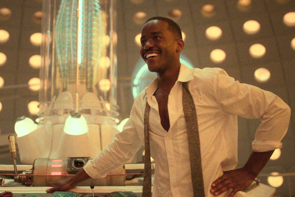 Rwandan-Scottish actor Ncuti Gatwa on set of 'Doctor Who' in the TARDIS, smiling.