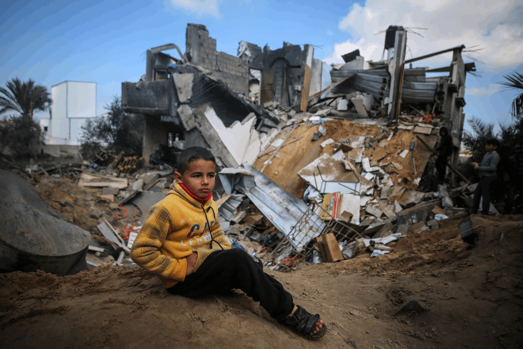 a child sitting in the rubble after Israeli bombardment in Deir Al-Balah, in the central Gaza Strip